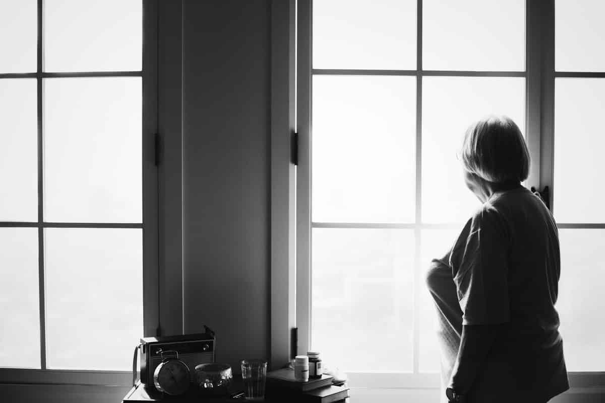 24/7 senior home care - Senior woman standing alone at home